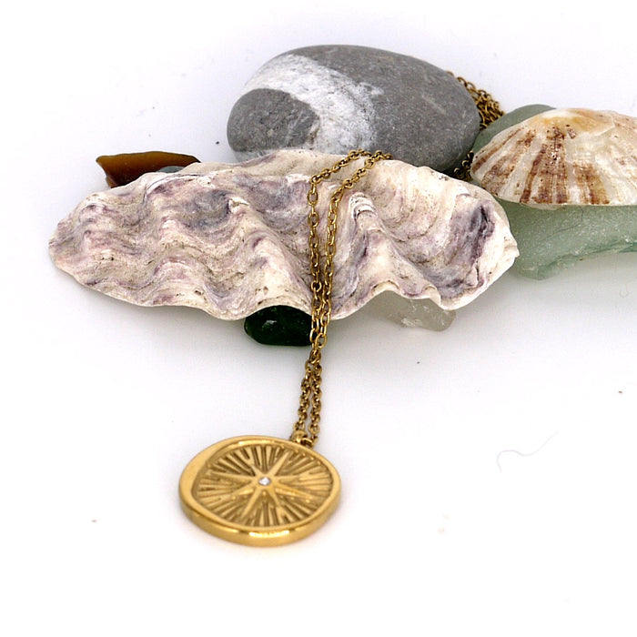 Wax Seal Starburst Necklace – flat lay